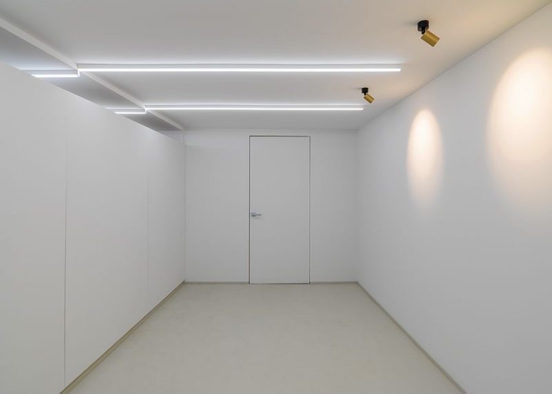 Minimalist room, closed doors, linear lighting. Perfect for meeting, inspiration and creative communication.